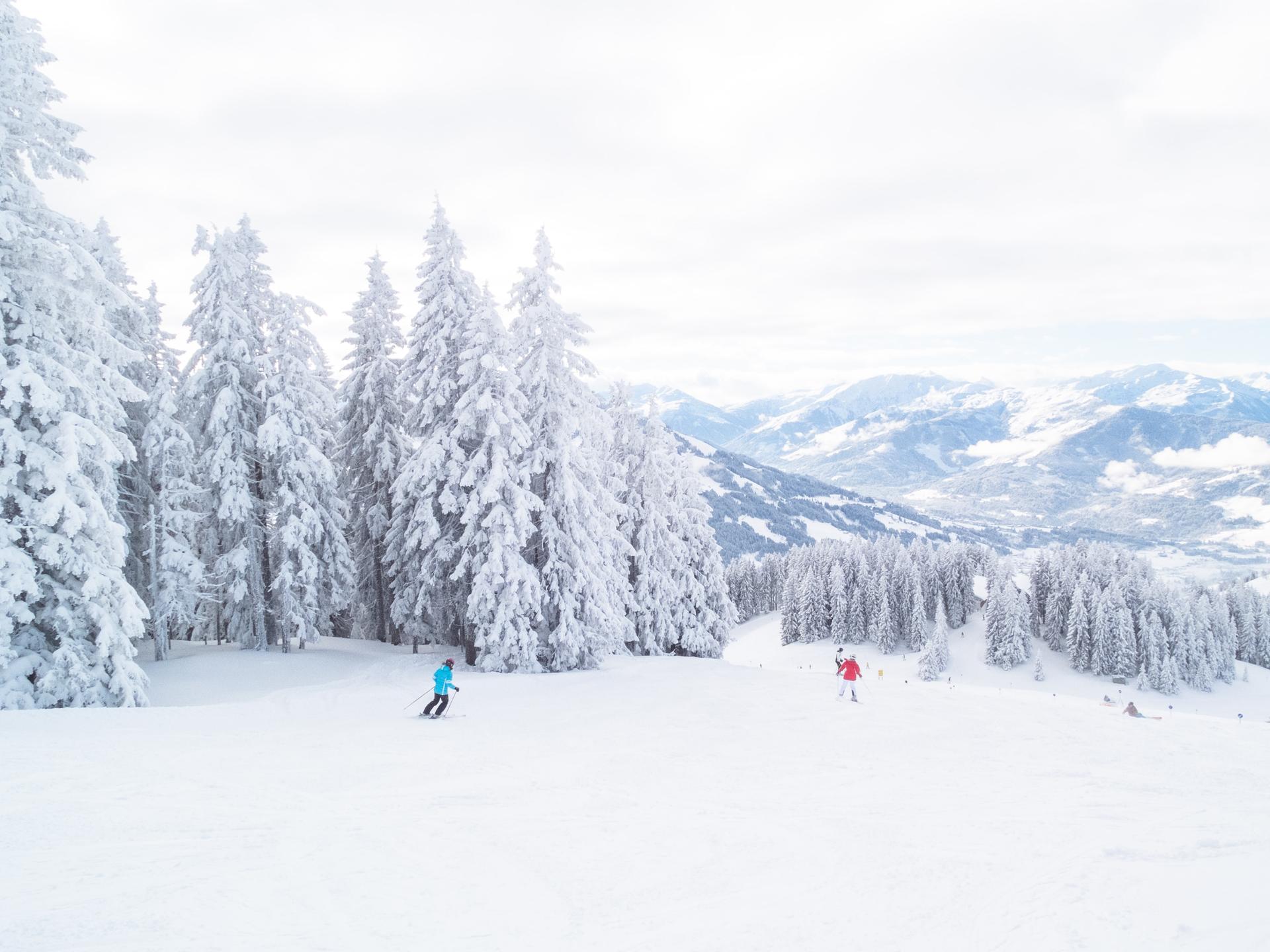 Skiiers skiing down snowy mountain in Austria